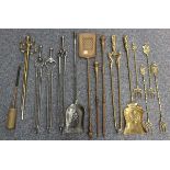 A collection of various 19th and early 20th century brass and steel fire tools, together with a