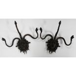 A pair of 20th century brown patinated cast bronze wall sconces, each modelled as a mask of