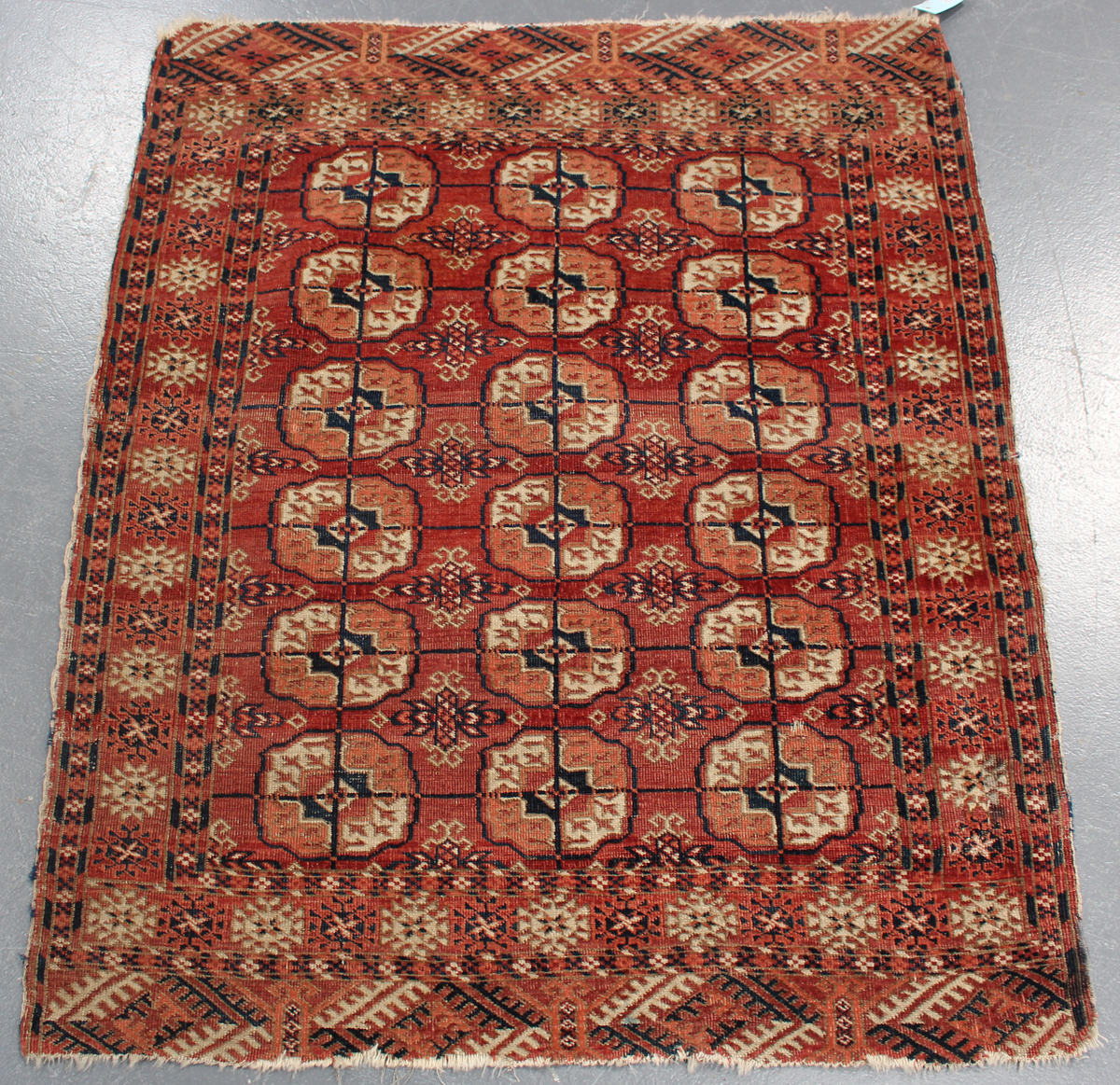 A small Tekke rug, West Turkestan, early 20th century, the claret field with three columns of