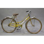 A mid-20th century French bicycle by Motobécane, with gilt frame and front light.Buyer’s Premium