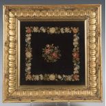 A late Victorian Berlin woolwork, worked with flowers on a black ground, 22cm x 22cm, within a later