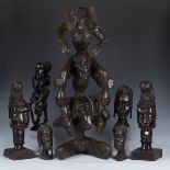 A group of African hardwood carvings, including a large figural and elephant sculpture, height 87cm,