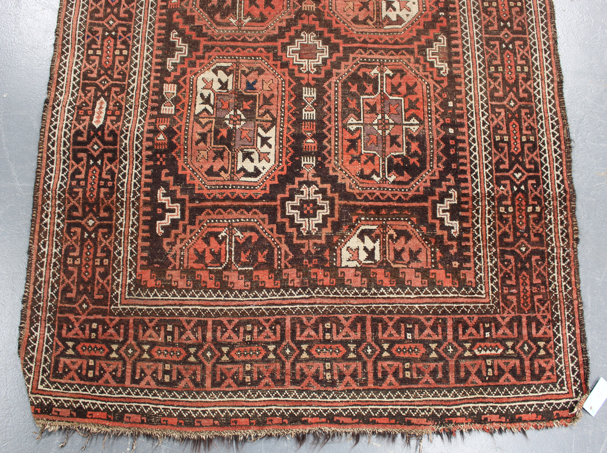 A Beluche rug, Afghan/Persian borders, early 20th century, the red field with six medallions, within - Image 3 of 4