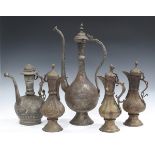 A group of five Middle-Eastern engraved brass coffee pots of baluster form, probably Afghanistan,
