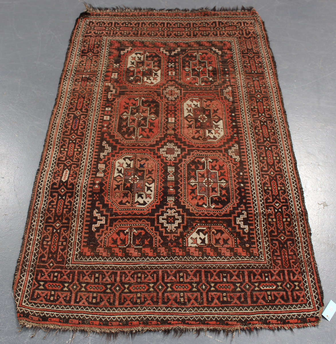 A Beluche rug, Afghan/Persian borders, early 20th century, the red field with six medallions, within