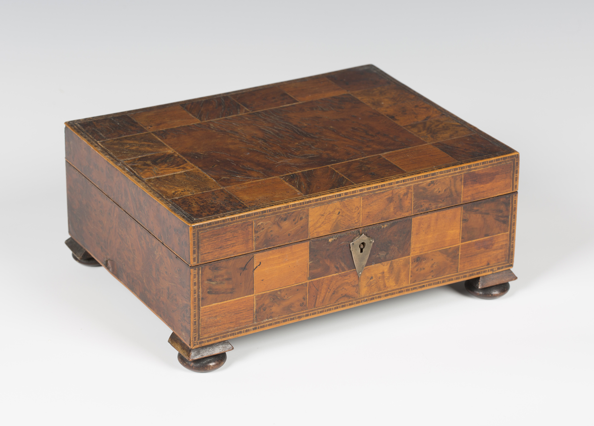 A 19th century specimen wood work box, the hinged lid and sides with overall squares of various