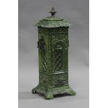 A late 19th century green enamelled 'Veritas' stove heater of pierced form, fitted with a