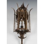An early 20th century ecclesiastical gothic gilt wrought metal lantern on a spiral reeded stem