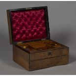 A late Victorian walnut lady's workbox, the hinged lid enclosing a compartmentalized tray, the front