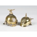 Two early/mid-20th century brass miniature novelty models of pickelhaube helmets, one fitted as an