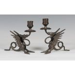 A pair of 20th century Victorian style brown patinated cast bronze chambersticks in the form of