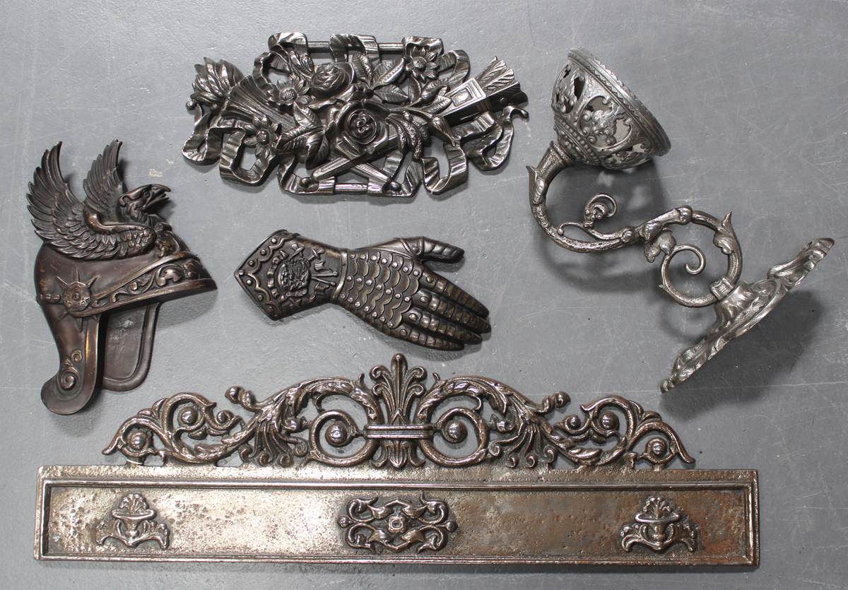 A group of late 19th and early 20th century decorative cast iron and polished steel items, including