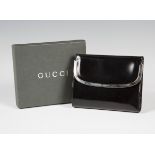 A Gucci black patent leather purse with plated clasp, width 13.2cm, together with original