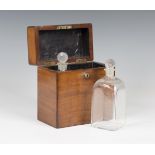 A Victorian mahogany decanter box, the hinged lid revealing a pair of glass decanters and stoppers