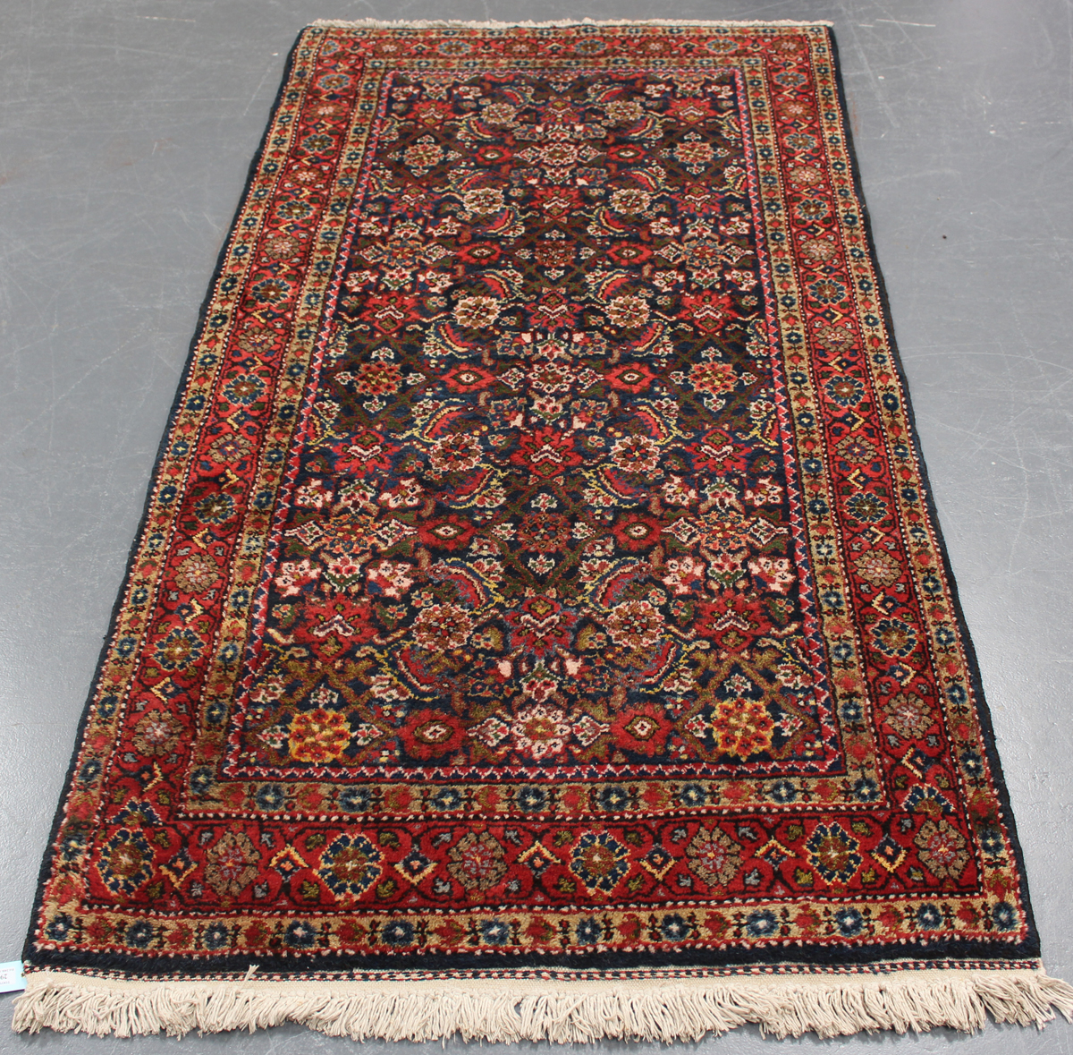 A Hamadan rug, North-west Persia, mid-20th century, the midnight blue field with an overall herati