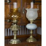 A late Victorian brass table oil lamp with a blue glazed stoneware body, the winding mechanism