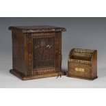 A late Victorian carved oak table-top box, the door carved with heraldic crest above dates '1393-