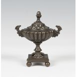 A Regency brown patinated cast bronze pastille burner of reeded urn form, the pierced lid and body