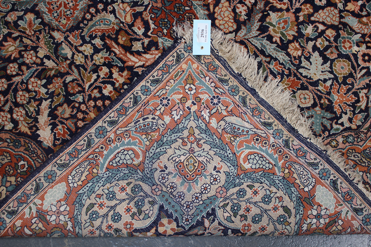 A Turkish part silk rug, late 20th century, the midnight blue field with a flowerhead medallion, - Image 2 of 4