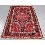 A Hamadan rug, North-west Persia, mid-20th century, the charcoal field with a bold medallion,