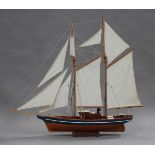 A mid/late 20th century model pond yacht with cloth sails and string rigging, length 123cm.Buyer’s