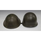 A late 20th century Nato M1 type helmet, together with a 1970s British Mk III turtle style helmet, a