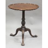 An early 20th century George III style mahogany tip-top wine table, the carved piecrust top above