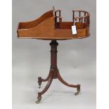 A late 20th century reproduction stained hardwood butler's stand, the tripod base fitted with