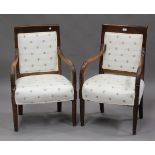 A pair of 19th century French walnut showframe armchairs, upholstered in bee-patterned white damask,