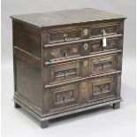 A William and Mary oak chest of four drawers, the front with applied geometric mouldings, raised