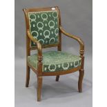 A French Empire provincial walnut framed armchair, the scrolling back and bowfront seat