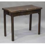 A George III mahogany fold-over serpentine front fold-over card table, raised on moulded block legs,