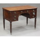 A William IV mahogany kneehole writing table, in the manner of Gillows of Lancaster, the curved