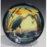 A Moorcroft Heron Reeds at Sunset pattern charger, circa 1992, designed by Philip Richardson,