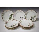 A set of twelve Limoges plates, early 20th century, painted with different flowers and insects below