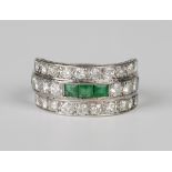 An emerald and diamond ring in a three row design, mounted with three rows of three square cut