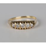 A gold and diamond five stone ring, mounted with a row of graduated cushion cut diamonds, ring