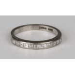 An 18ct white gold and diamond half-hoop ring, set with a row of twelve square cut diamonds, ring