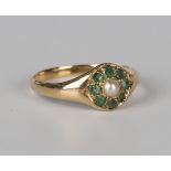 A gold ring, mounted with a central half-pearl within a surround of eight emeralds, ring size approx