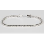 An 18ct white gold and diamond line bracelet, claw set with a row of circular cut diamonds, each