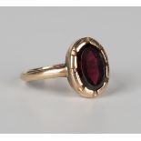 A gold ring, mounted with an oval cut garnet, ring size approx M1/2.Buyer’s Premium 29.4% (including
