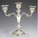 An Elizabeth II silver twin-branch candelabrum with detachable beaded nozzles, on a tapering