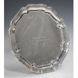 A George V silver salver with engraved presentation inscription within a lobed octagonal pie crust