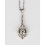 A diamond pendant of angular pierced geometric form, claw set with the central circular cut diamond,