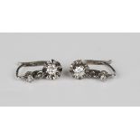 A pair of French diamond two stone earrings, each mounted with a circular cut diamond to the drop