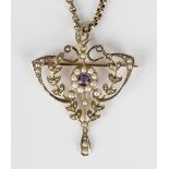 A gold, amethyst and seed pearl pendant brooch in a pierced openwork and foliate design, detailed '