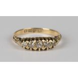 An 18ct gold and diamond five stone ring, mounted with a row of cushion cut diamonds graduating in