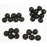 A collection of black composition beads representing the nations of the United Kingdom, comprising