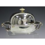 A George V silver muffin dish and cover with warmer base, fitted with turned ivory finial and