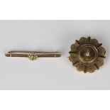 A Victorian 15ct gold and diamond brooch of shaped circular form, star set with the cushion cut